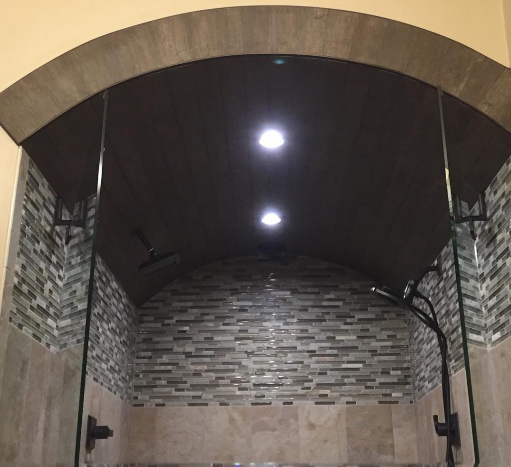 fancy custom shower with arch tile stone