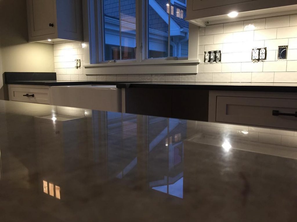 polished counter and tile backsplash